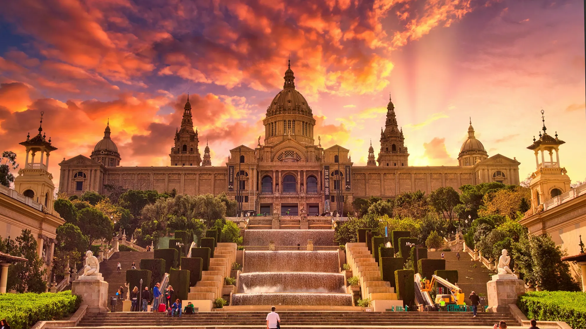 Palau Nacional and its fountain staircase under a dramatic sunset sky, Barcelona