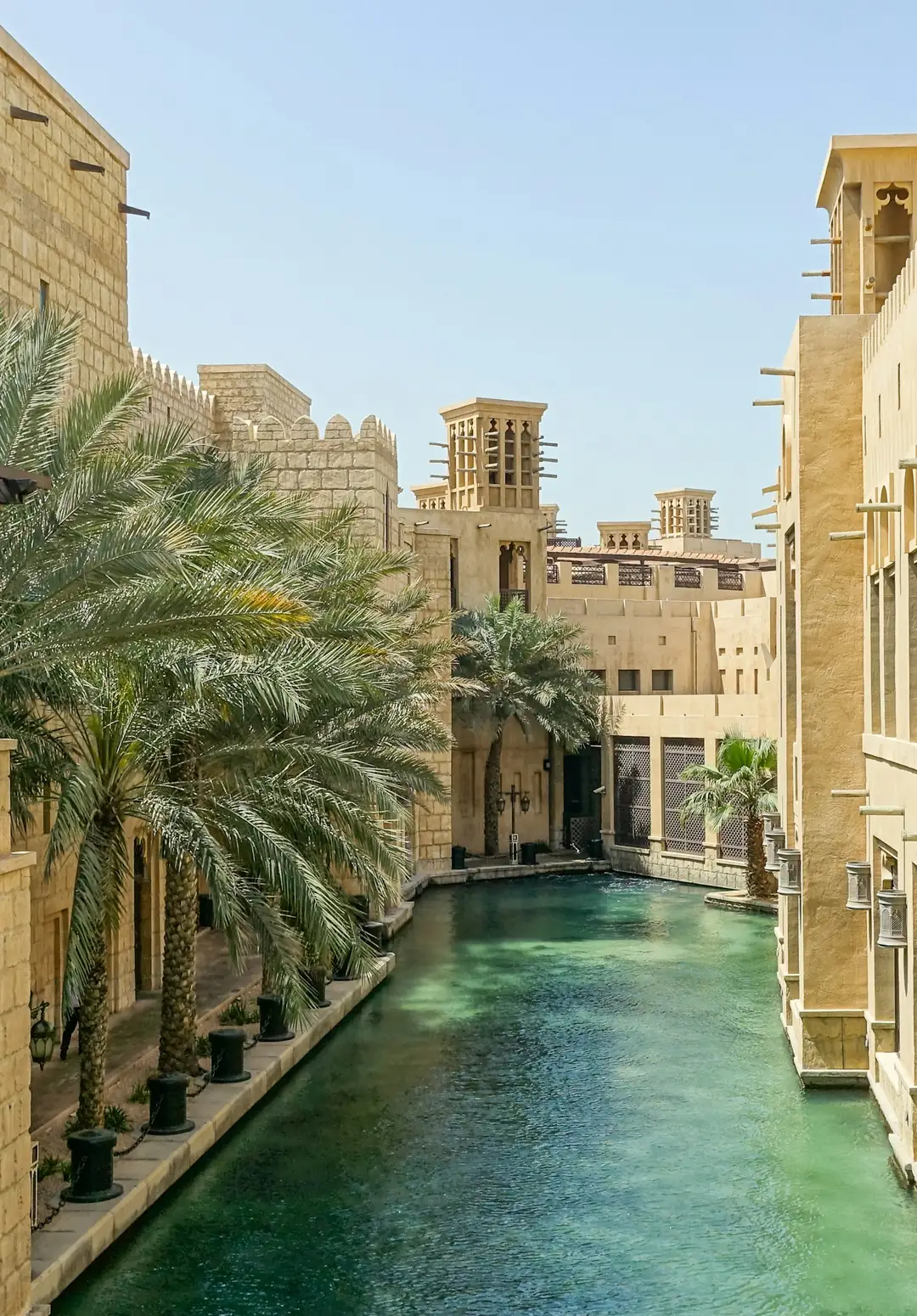 Waterway winding between Arabian wind-tower buildings at Madinat Jumeirah, Dubai