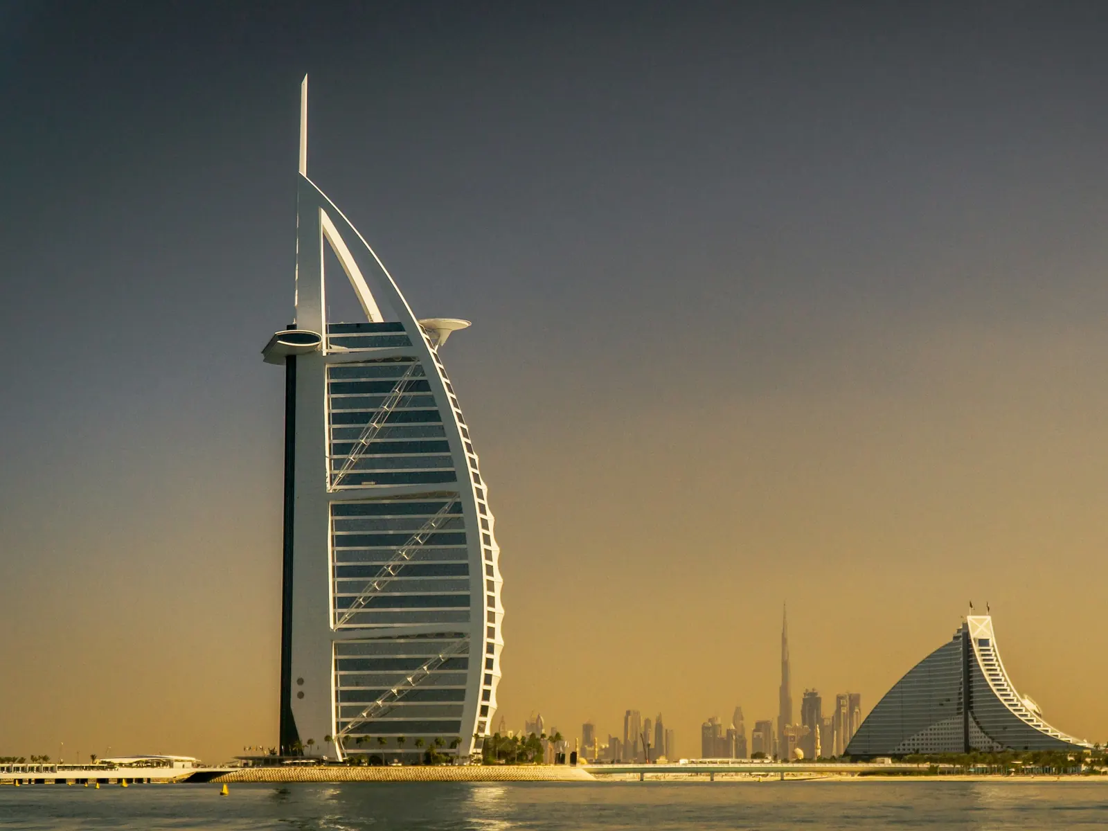 The sail-shaped Burj Al Arab hotel on the Dubai coast at golden hour